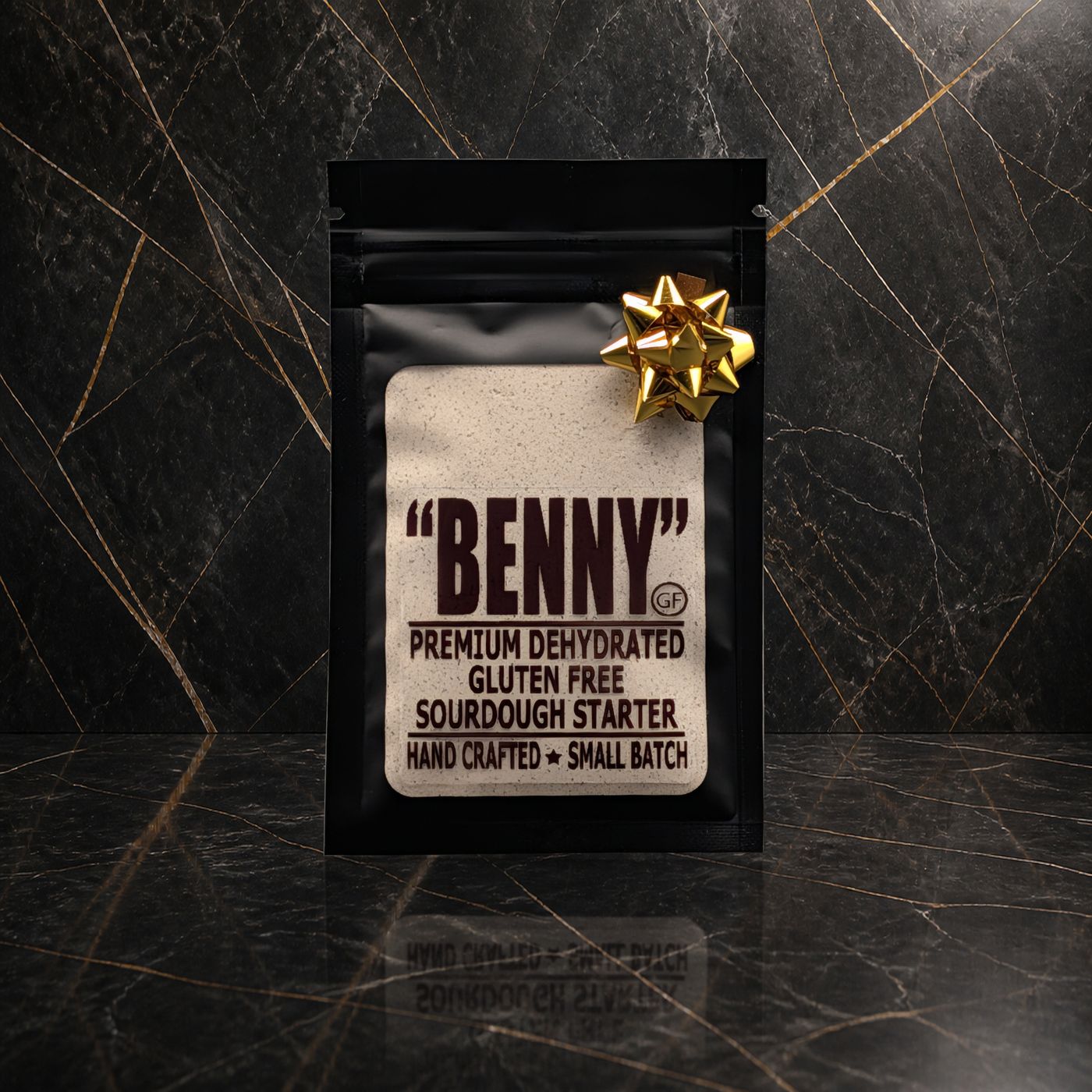 Benny Gluten Free sourdough starter pouch with a gold bow on black marble