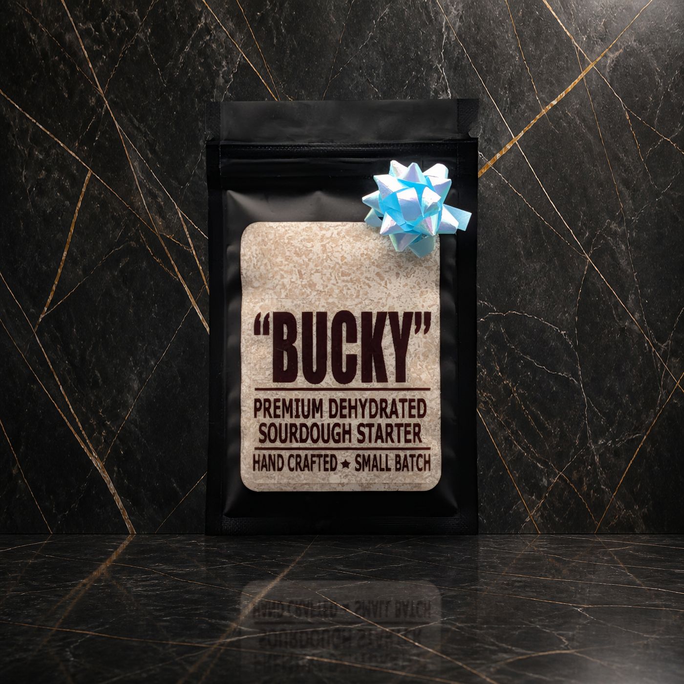 Bucky dehydrated sourdough starter pouch with a blue bow on black marble